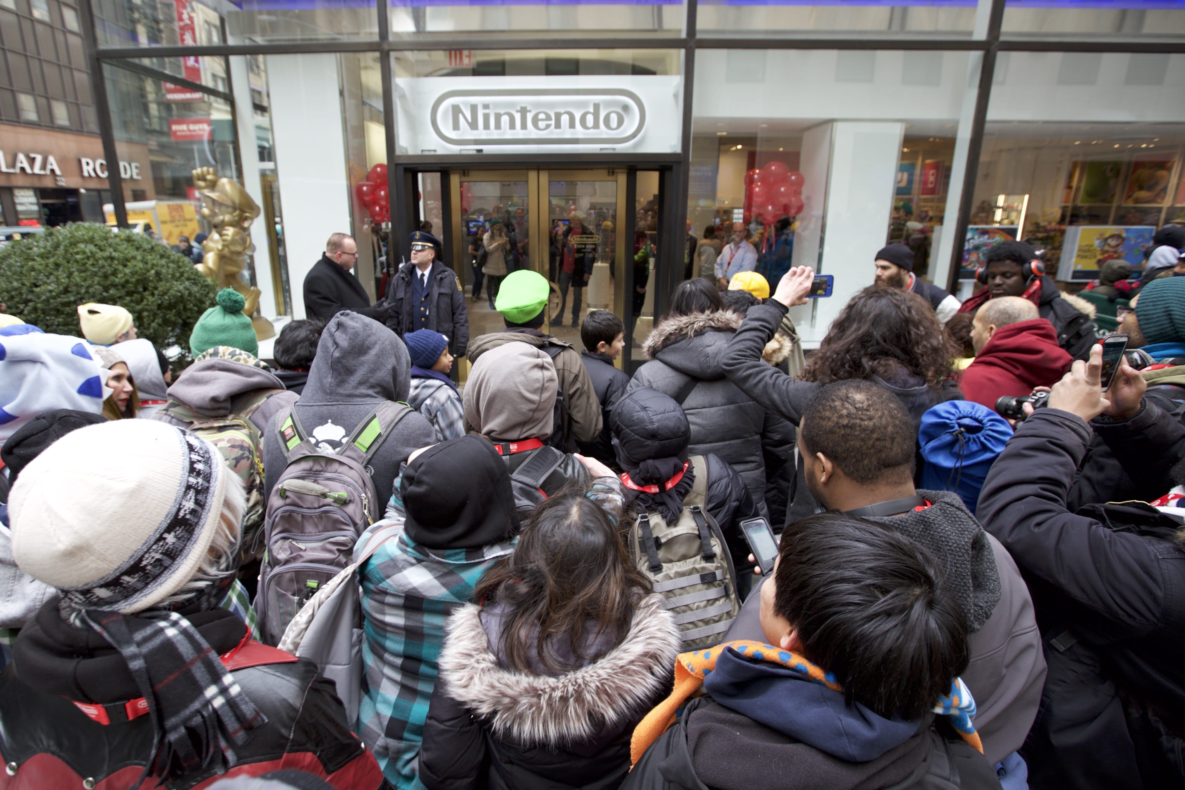 In this photo provided by Nintendo of America, Nintendo fans eagerly await to enter the grand reopening of the remodeled Nintendo NY store on 19th February 2016.
