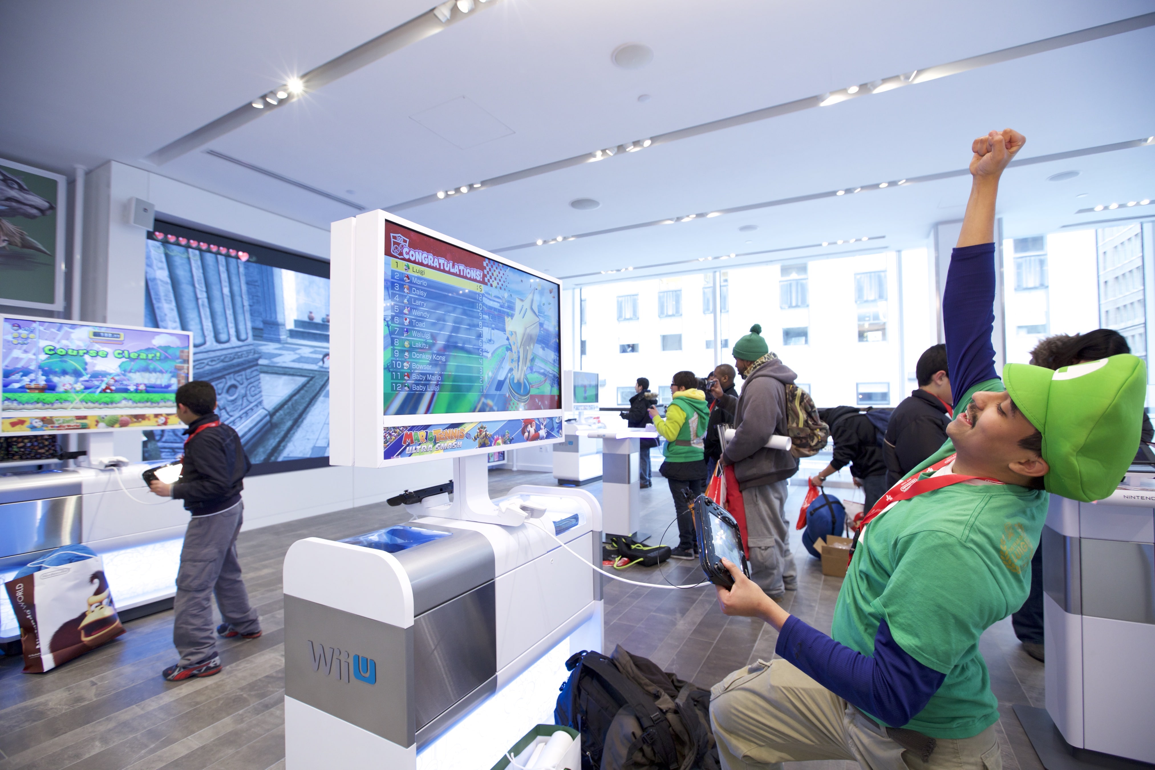 In this photo provided by Nintendo of America, Rinaldy G. of New York plays Mario Kart 8 using the Nintendo NY store’s upgraded Wii U demo units at the store's reopening on 19th February 2016.